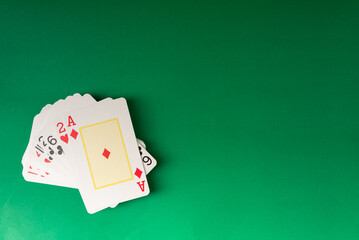 Playing cards isolated on green background.