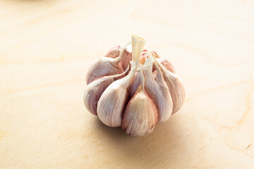 Close-up garlic bulb with segments, top view. Organic garlic for publication, poster, calendar, screensaver, wallpaper, post, banner, cover. High quality photo