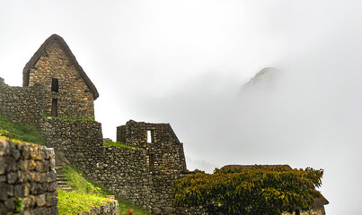ancient town in machu picchu. Antique houses of the incas in a cloudy day and 
