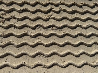 Tyre tracks were imprinted in the sand.