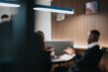 A blurred image capturing the essence of teamwork with business colleagues deeply engaged in...