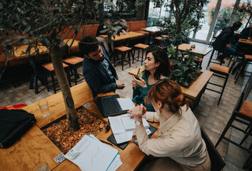 A dynamic startup team is seen discussing business strategies over coffee in a modern urban cafe.