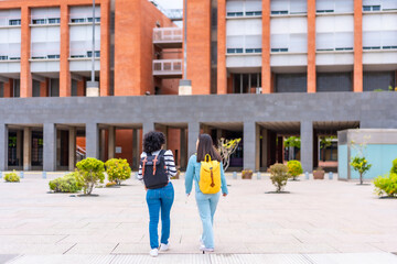 Women walking outside the university to the entrance