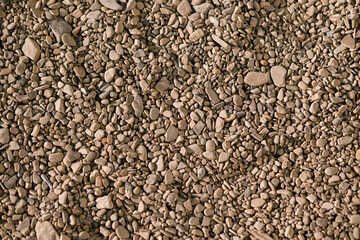 Pebbles background. Top view of river stones shingle , mineral material for pathways in modern urban garden or construction site