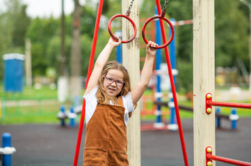 portrait of a happy smiling girl 6 years old playing on a children's playground.looks at the camera close-up. High quality photo