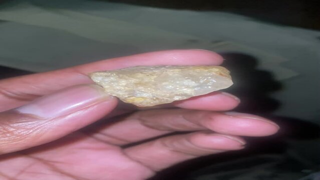 hand holding a crystal

