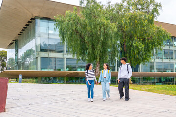 Full length photo of students walking along the university campus