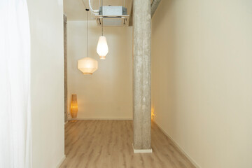 Minimalist corner with paper lamps and a concrete column.