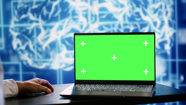Computer scientist using green screen laptop to implement artificial intelligence parallel processing. Manager overseeing chroma key device enabling AI systems to do machine learning inference