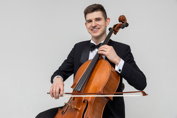 Musician sitting on chair playing cello