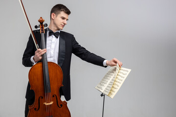 Young male musician performing with cello and music note