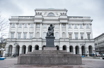 Statue of Nicolaus Copernicus with the facade of the Society of Friends of Science in the city of...