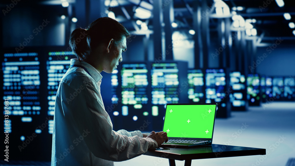 Poster it consultant running code on chroma key laptop, troubleshooting data center equipment. cloud comput