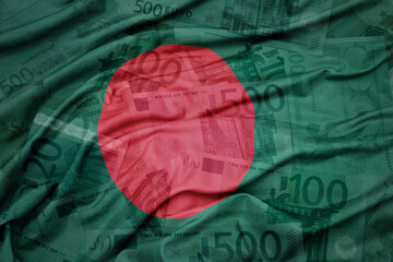 waving colorful national flag of bangladesh on a euro money banknotes background. finance concept.