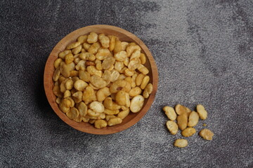 Koro beans (Kacang Koro or Kacang Parang), a type of legume, contain protein, a traditional snack from Indonesia. served on wooden bowl