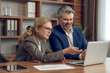 Psychologists cooperating in psychotherapy session studying psychological articles discussing together