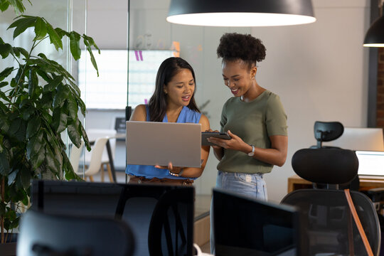 At office, diverse female business colleagues discussing work