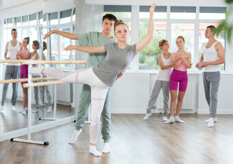 Ballet studio - teenagers learn ballet movements in pairs