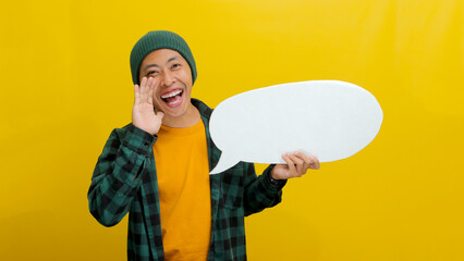 A young Asian man, sporting a beanie hat and casual shirt, positions his hand near his mouth, as if...