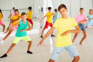 Group of fashionable children learning a modern dance while having a choreography class. Dance...