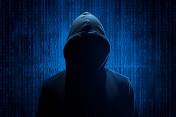A silhouette of a hacker in a hoodie, against a backdrop of digital binary code in shades of blue, symbolizing data or cyber security concepts 