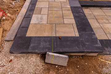 home construction: patio and walkway paving stone instalation in progress at a new house build in...