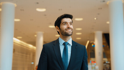 Portrait imaged of professional business man looking around at mall. Executive manager standing at...