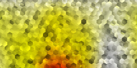 Light red, yellow vector backdrop with a batch of hexagons.