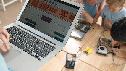 Top view of smart caucasian teacher coding engineering prompt and generated AI while diverse...