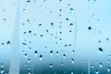 Condensation on window glass in frosty winter weather. Background in the form of small drops on the glass.
