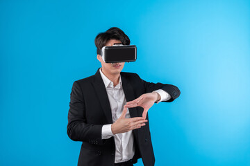 Asian businessman looking thorough VR try to zoom in or out with connecting business world report...