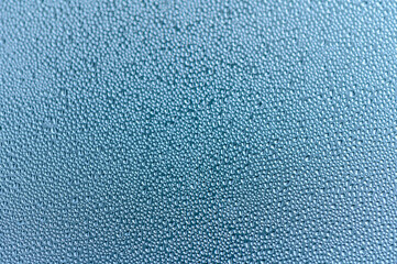 Raindrops on the window. Blue tone