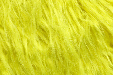 Texture of yellow faux fur as background, closeup