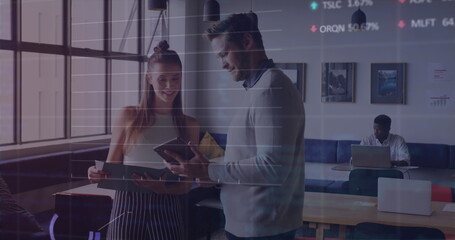 Image of stock market data processing against diverse man and woman discussing at office
