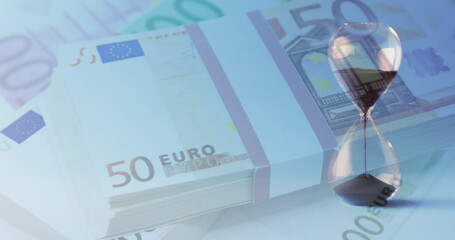 Image of euro currency banknotes over hourglass