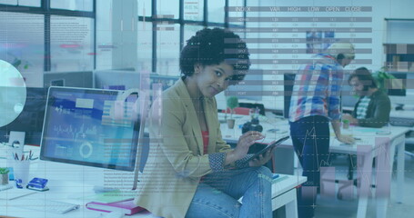 Image of statistical data processing over african american woman using digital tablet at office