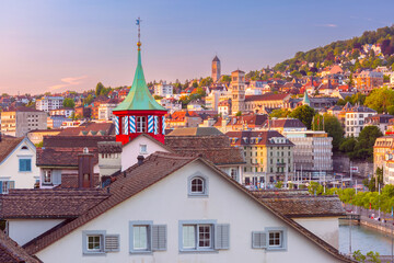 Aerial view over roofs and towers of Old Town of Zurich, Switzerland at sunset.