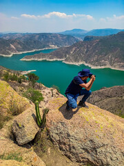 Photographer on Mountain Top with River View