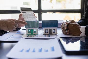 Real estate agent, house model, close up of house, keys and small toy house on table, lawyer, legal...
