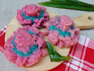 Kue carabikang or carabikang cake placed on wooden cutting board. Sweet cake from Indonesia made from rice flour and coconut milk.