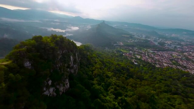 An aerial FPV view peak of rocky hills Bukit tabur during morning.