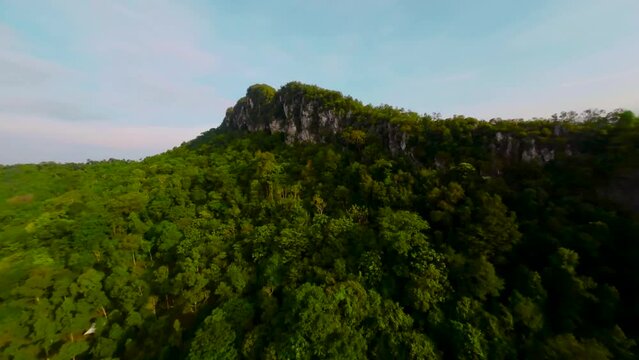 An aerial FPV view peak of rocky hills Bukit tabur during morning.
