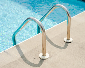 Swimming Pool With Two Metal Stair Rails