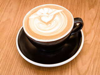Elegant Swirls of Latte Art on Wooden Table