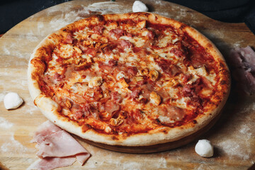 Savory Delight: Ham and Cheese Pizza on Cutting Board