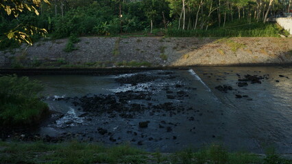 the rapid flow of water coming out of the dam