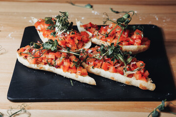 Vibrant Bruschetta Delight,A plate brimming with freshly made bruschetta topped with juicy tomatoes 