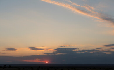Landscape with bloody sunset. Panorama. Tragic gloomy sky. The last flashes of the sun on the storm...