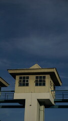 Buildings on top of a water storage dam, vertical photo of dam