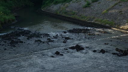 the rapid flow of water coming out of the dam
